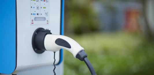 Electric car charging plug in power station